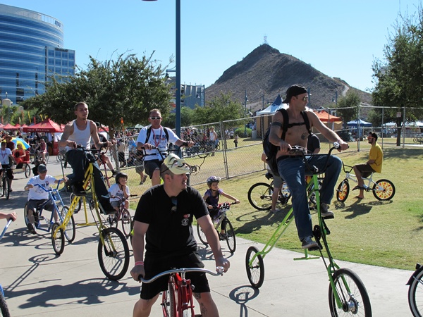 Photo is a guy riding a bike that has long forks and a high middle, so he�s about 4 feet up in the air.