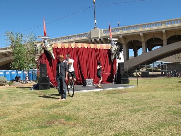 Photo is of a stage with the Yo-Yo master on a unicycle.