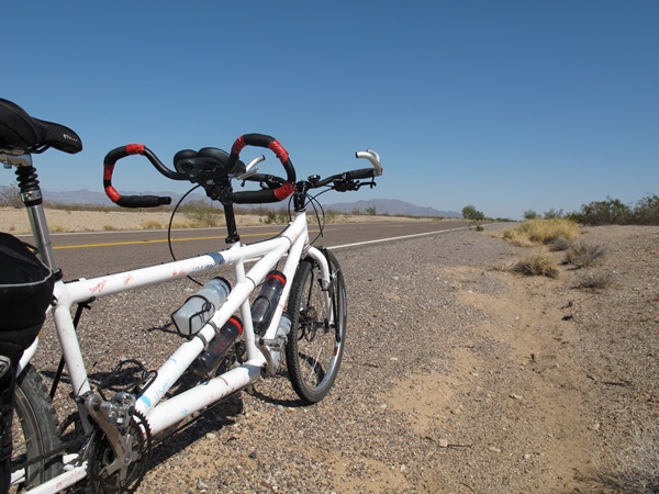 Photo is of the long stretch of flat highway ahead of us. An empty road.
