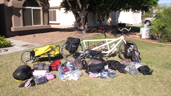 Photo of tandem bike with trailer.  In front of the bike is all the gear we will be taking with us: camping gear, bike gear, etc... 